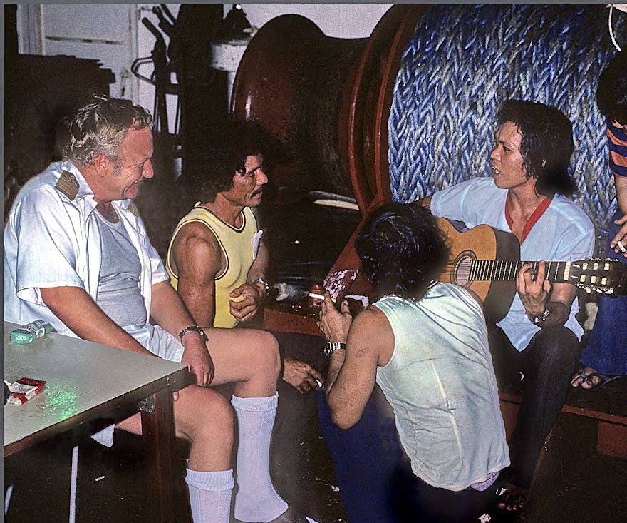Before the storm - 1977-11-041 Party on the poop deck, - Capt. Oddenes is being entertained by the crew.   