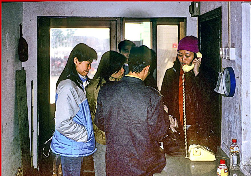 2002-02-085  -  Xiao Ling on the phone,-  pulling strings in the guard house - (Photo- and copyright: Karsten Petersen)