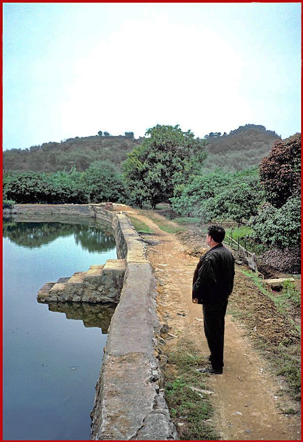 2002-03-021  - Danes Island - fish pond, - our local guide, - and Cemetery Hill behind - (Photo- and copyright: Karsten Petersen)