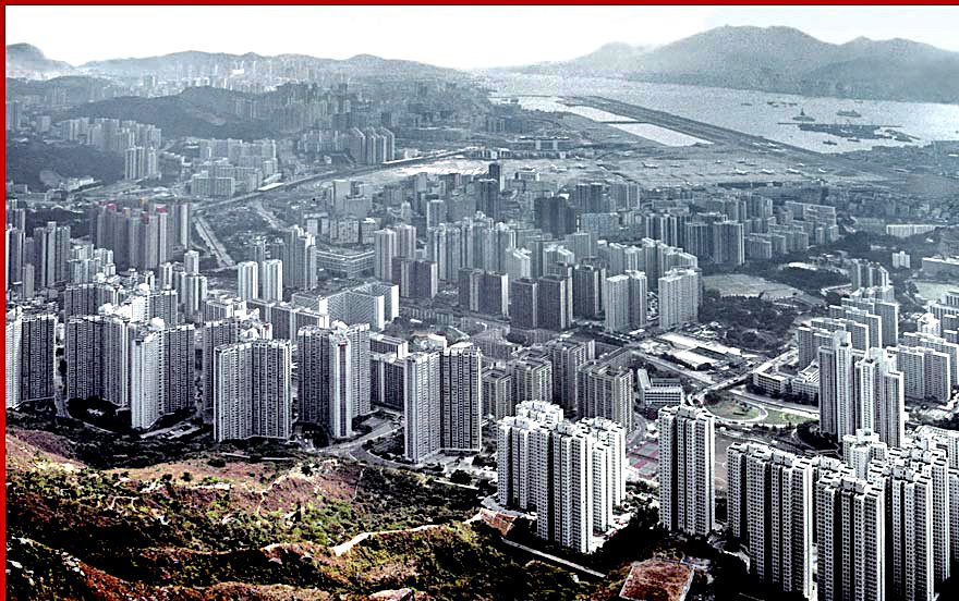1997-02-060  - A view from another direction, - the Kowloon side. - a misty look over Tsz Wan Shan apartments, - and Kai Tak Airport in the background  -  (Photo- and copyright:  Karsten Petersen)-