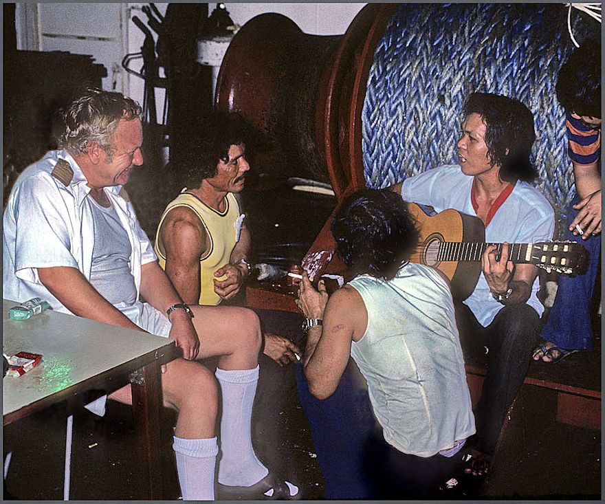 Before the storm - 1977-11-041 Party on the poop deck, - Capt. Oddenes is being entertained by the crew.   