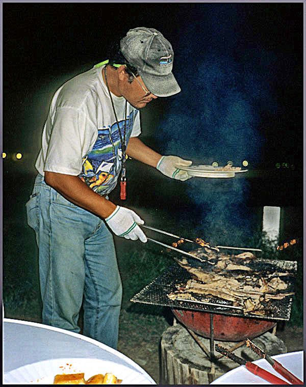 2000-16-096 - Later Mr. Yo prepares dinner, - our catch - grilled fish. -  (Photography by Karsten Petersen ©)