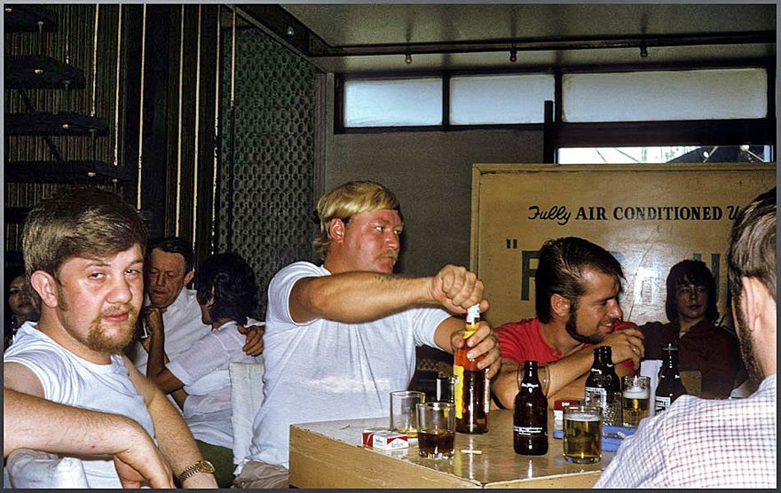 1972-02-032 Now in Cebu, - Philippines -, where the waterfront in those days were filled with sailor's bars, - just down the gangway - Here the Chief Cook looks rather tired, - while AB Odd Oddnes handles a bottle of 
