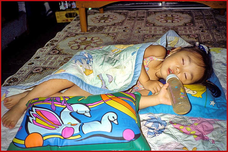 1997-21-081 - My favourite - the daughter of the owner of the restaurant where I used to eat -  - time to sleep after a long days activities - (Photography by Karsten Petersen)