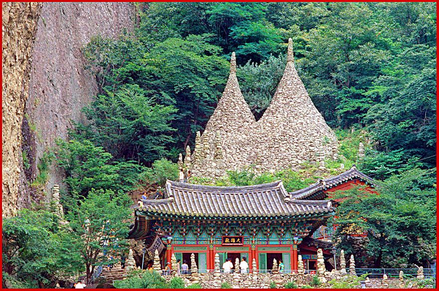 1997-20-052 - Maisan - a closer view of Tapsa's main hall with the two impressive 10 meters high stone pagodas behind - (Photography by Karsten Petersen)