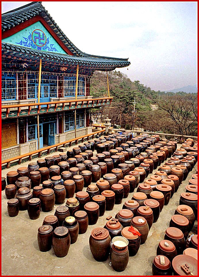 1996-34-015 - Doseon-sa Temple - kimche jars lined up behind the temple - (Photography by Karsten Petersen)