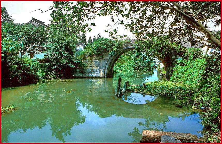 2002-25-H47  - A Ming Dynasty bridge, - old and overgrown -, but still in use - -