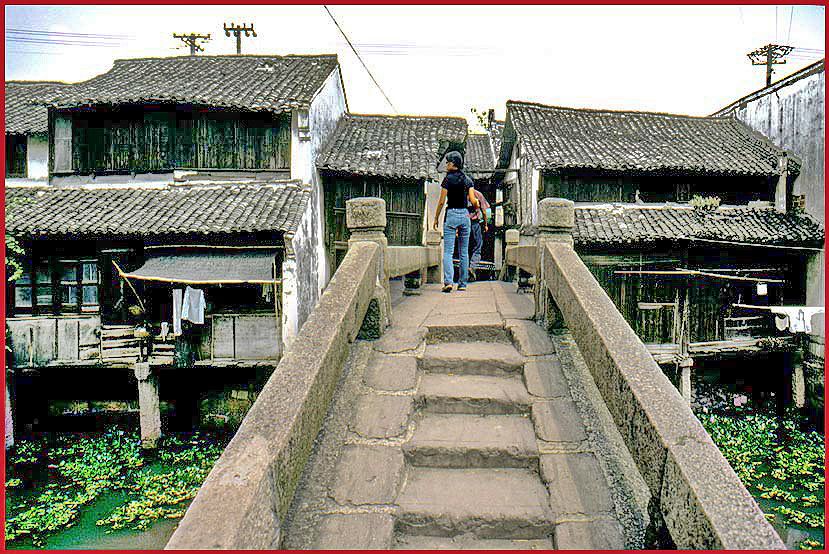 2002-25-V40  - Kit Yu crossing the bridge - entering the street system along the canal - - -