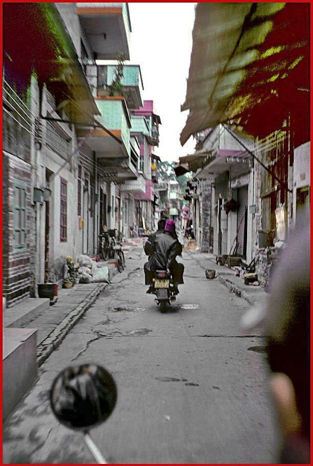 2002-03-013  - Danes Island  - on our way through the back streets, -  Xiao Ling in front - (Photo- and copyright: Karsten Petersen)