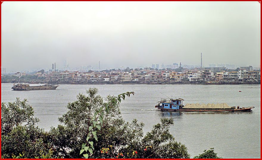 2002-03-024  - Danes Island -  View from the new Cemetery Hill towards America Reach to the very left. Also to the left is the Whampoa pagoda, which can be seen in the mist as the first vertical structure. (Photo- and copyright: Karsten Petersen)