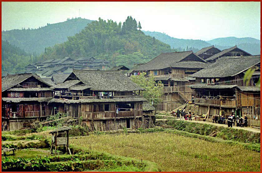 Film-2 Frame-11  - Dong Village Another shot from village Ping.  The people with the white headdresses are from a burial party  -  (Photo- and copyright: Karsten Petersen)