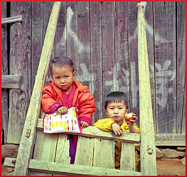 Film-1 Frame 12  - The Dong People - small boys, - totally ignoring the wall writing -  