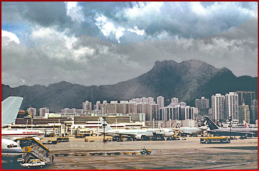 1997-12-095  - Kai Tak Airport Here a view towards the Lion Rock seen from Kai Tak airport. From this angle it is quite obvious why the mountain is called Lion Rock  -  (Photo- and copyright: Karsten Petersen)