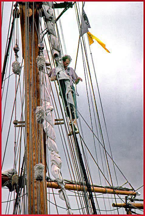 1992-07-097  - Working aloft - crew member securing the rigging, - 