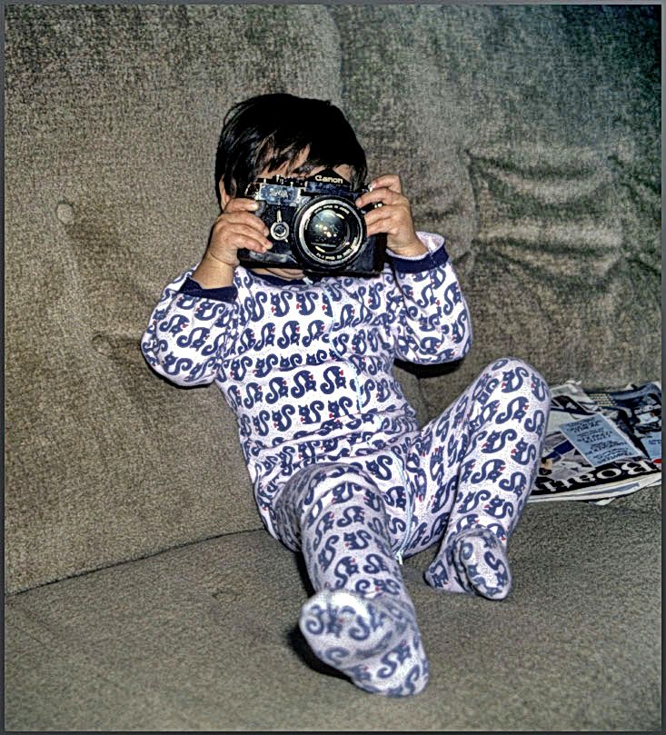 1981-01-062  -  The first introduction picture is of my son - Jesper - about 3 years old - playing with my favorite camera - the Canon F 1 - -